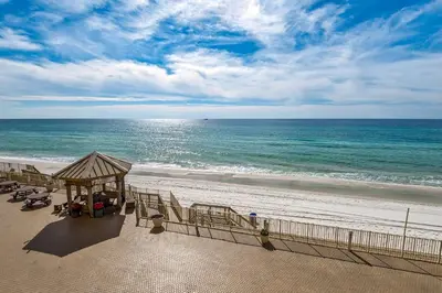 a view of a beach with a gazebo and the ocean at Treasure Island 0307 in Panama City Beach