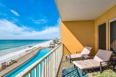 a balcony with a view of the beach and the ocean at Treasure Island 0307 in Panama City Beach