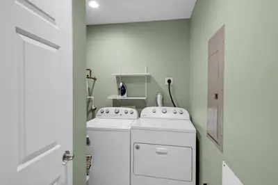 a white laundry room with a washer and dryer at Treasure Island 0307 in Panama City Beach