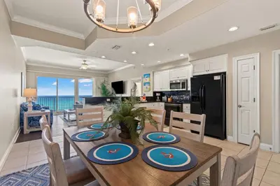 a kitchen and dining room with a table and chairs at Treasure Island 0403 in Panama City Beach