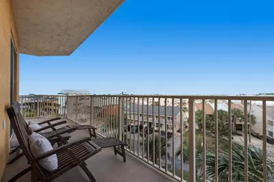 a balcony with chairs and a view of the ocean at Treasure Island 0412 in Panama City Beach