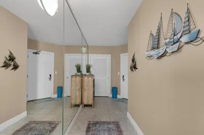 a room with a glass door with two boats on the wall at Treasure Island 0412 in Panama City Beach