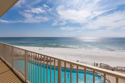 a balcony with a view of a beach and the ocean at Treasure Island 0411 in Panama City Beach