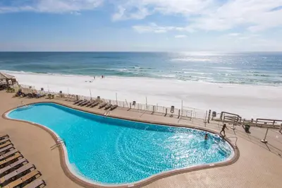 an overhead view of a swimming pool next to the beach at Treasure Island 0411 in Panama City Beach