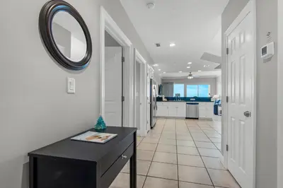 a hallway with a table and a mirror on the wall at Treasure Island 0506 in Panama City Beach