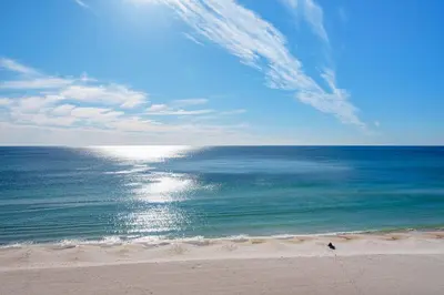 a person walking on a beach near the ocean at Treasure Island 0503 in Panama City Beach