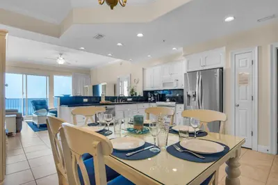 a kitchen and dining room with a table and chairs at Treasure Island 0503 in Panama City Beach