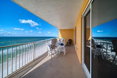 a balcony with chairs and a view of the ocean at Treasure Island 0906 in Panama City Beach