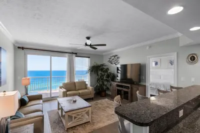 a living room with a view of the ocean at Treasure Island 1003 in Panama City Beach