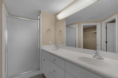 a bathroom with two sinks and a large mirror at Treasure Island 0809 in Panama City Beach