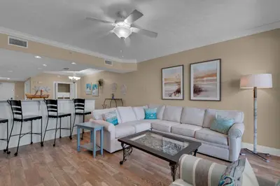 a living room with a couch and a table at Treasure Island 0809 in Panama City Beach