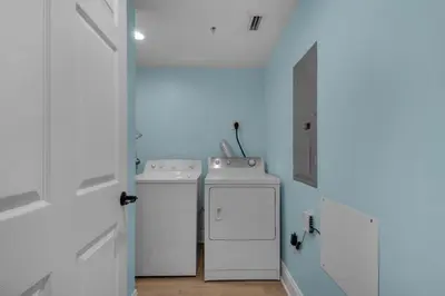 a laundry room with two washes and a washer and dryer at Treasure Island 1107 in Panama City Beach