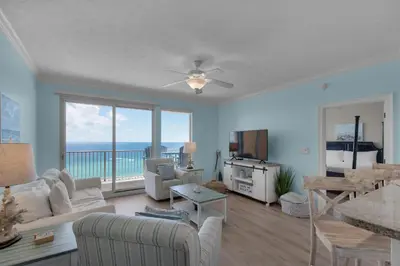 a living room with a view of the ocean at Treasure Island 1107 in Panama City Beach