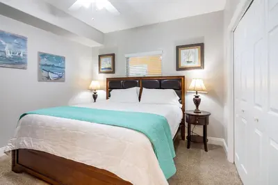 a bedroom with a large bed and two lamps at Treasure Island 1109 in Panama City Beach