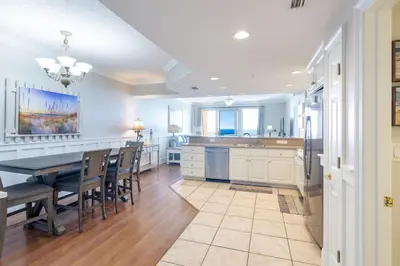 a large kitchen with a table and a dining room at Treasure Island 1109 in Panama City Beach