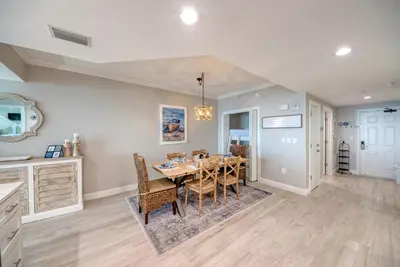 a kitchen and dining room with a table and chairs at Treasure Island 2006 in Panama City Beach