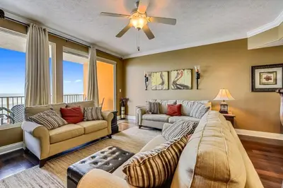 a living room with two couches and a ceiling fan at Treasure Island 2202 in Panama City Beach