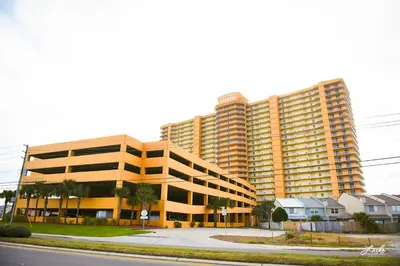 a large yellow building with a street in front of it at Treasure Island 2210 in Panama City Beach