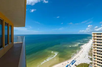 a view of the beach from the balcony of a building at Treasure Island 2312 in Panama City Beach