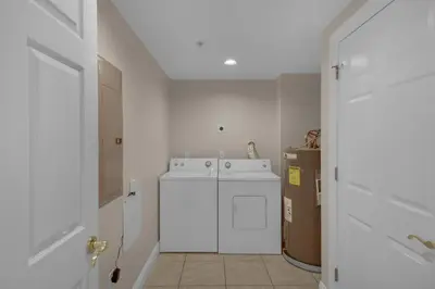a white laundry room with a washer and dryer at Treasure Island 2312 in Panama City Beach
