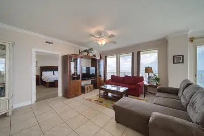 a living room with a couch and a tv at Treasure Island 2312 in Panama City Beach