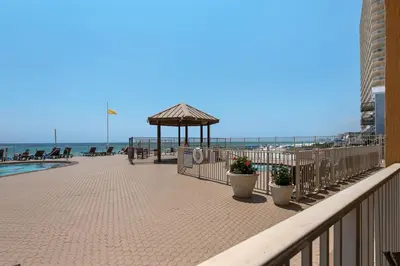 a boardwalk with a gazebo and the beach at Treasure Island 0111 in Panama City Beach