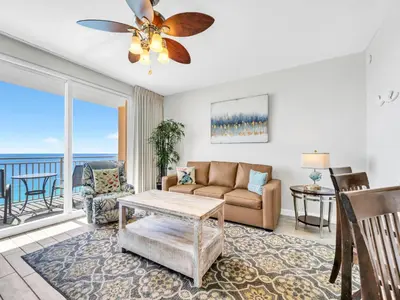 a living room with a couch and a ceiling fan at Splash 1505E in Panama City Beach