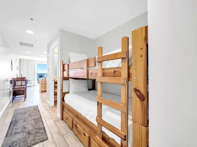 a bedroom with bunk beds with a ladder at Splash 1505E in Panama City Beach