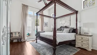 a bedroom with a canopy bed and a dresser at Saltwater Gospel in Inlet Beach