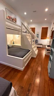 a bedroom with a bunk bed and a staircase at Saltwater Gospel in Inlet Beach