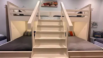 a bunk bed with white stairs in a room at Saltwater Gospel in Inlet Beach