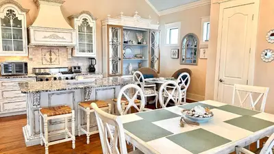 a kitchen and dining room with a table and chairs at Saltwater Gospel in Inlet Beach