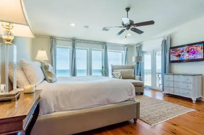 a bedroom with a bed and a ceiling fan at Pelican Paradise - Unit A in Seacrest