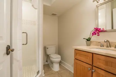 a bathroom with a toilet and a sink and a shower at Pelican Paradise - Unit A in Seacrest
