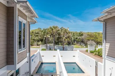 a view of a pool from a house at Pelican Paradise - Unit A in Seacrest
