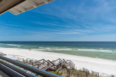 a view of the beach from the balcony of a beach house at Pelican Paradise - Unit A in Seacrest