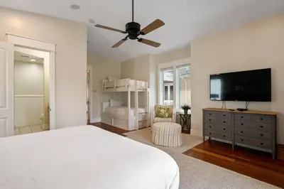 a bedroom with a bed and a flat screen tv at Pelican Paradise Unit B in Seacrest