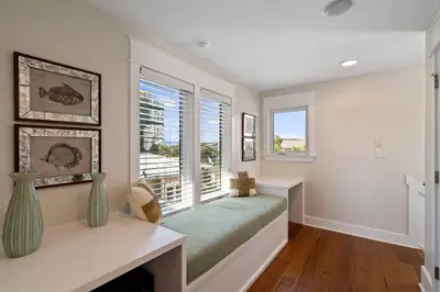 a bedroom with a bed and a window at Pelican Paradise Unit B in Seacrest