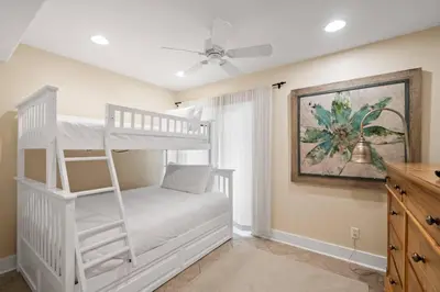 a bedroom with a bunk bed with a ladder at Pelican Paradise Unit B in Seacrest