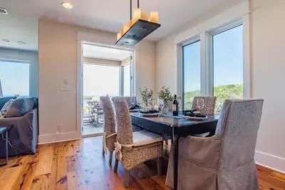 a dining room with a table and chairs at Pelican Paradise in Seacrest
