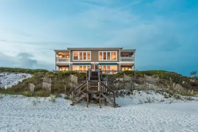 a house on top of a beach at Pelican Paradise in Seacrest