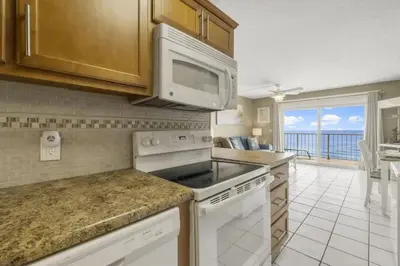 a kitchen with a stove and a microwave at The Summit 1128 in Panama City Beach