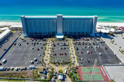 an aerial view of a large building with a parking lot at The Summit 1128 in Panama City Beach