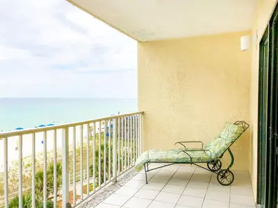 a chair sitting on a balcony overlooking the ocean at The Summit 611 in Panama City Beach