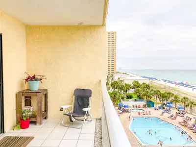 a balcony with a view of a pool and the beach at The Summit 611 in Panama City Beach