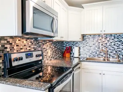 a kitchen with a stove and a microwave at The Summit 611 in Panama City Beach