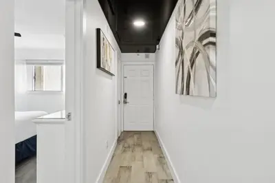 a hallway with white walls and a white door at The Summit 702 in Panama City Beach