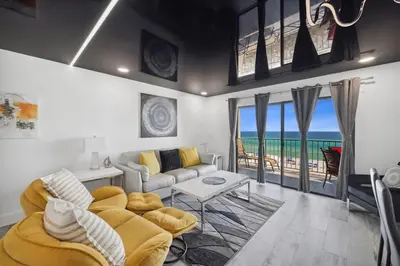 a living room with a couch and a table at The Summit 702 in Panama City Beach
