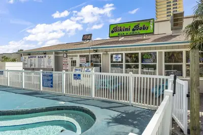 a restaurant with a pool in front of a building at The Summit 702 in Panama City Beach