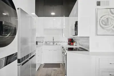 a white kitchen with white cabinets and a sink at The Summit 702 in Panama City Beach